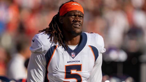Broncos pass rusher Randy Gregory looks on without a helmet before a game.